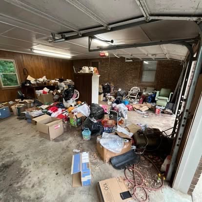 Garage overflowing with junk before cleanout in Concord NC area